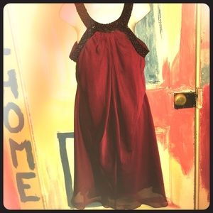 Semi-formal burgundy dress with black beading.